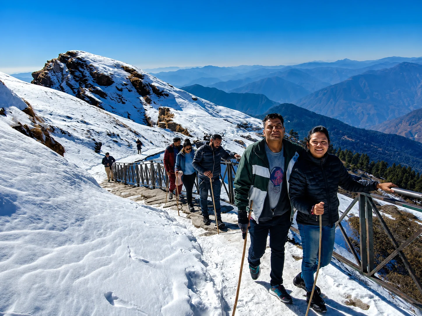 Trekkers climbing the snowy Chopta Tungnath trail, an active Uttarakhand holiday package for beginners