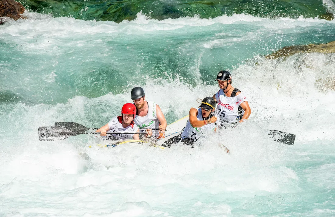 Rafters crashing through white water rapids, a favourite of adventure tour packages in Uttarakhand